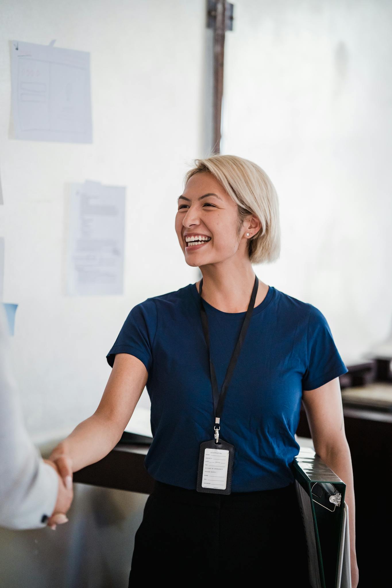 Friendly businesswoman shaking hands, confirming an HR audit